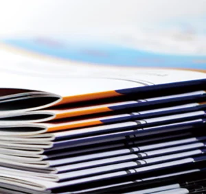 a close up of a stack of magazines on a table